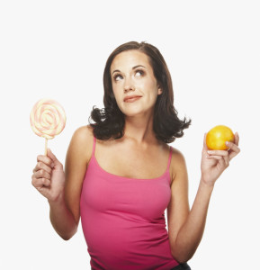Women with fruit in one hand and lollipop in the other