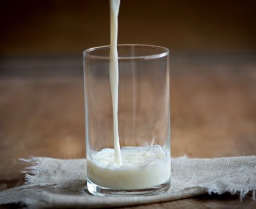 glass with milk being poured into it