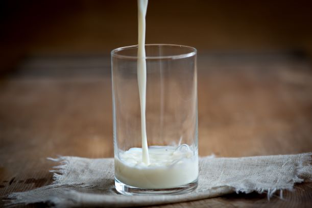 glass with milk being poured into it