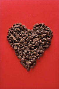 Red background with heart shaped out of chocolate chips