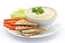 Hummus with pita bread, carrots and celery