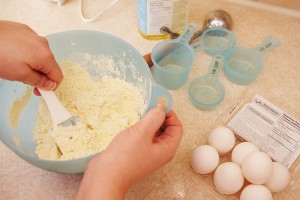 Measuring ingredients and mixing recipe in bowl
