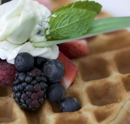 Waffles with berries and whipped cream