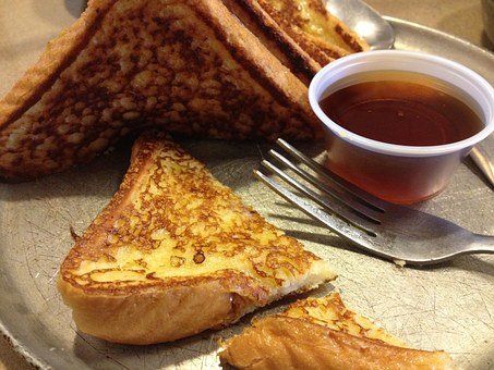 french toast with syrup in cup