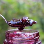 Fruit Jam on spoon coming out of jar