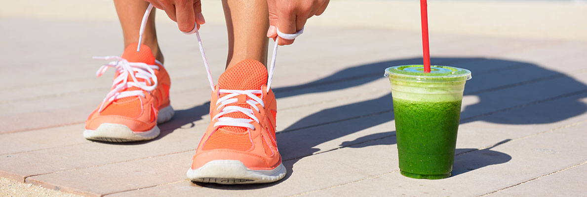 Orange tennis shoes and green drink
