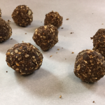 rolled date balls on parchment paper