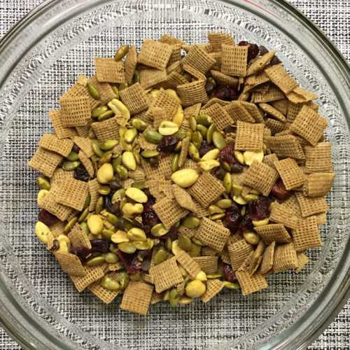 snack mix in glass bowl on placemat