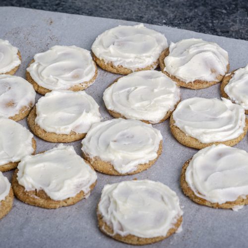 frosted cookies on parchment paper