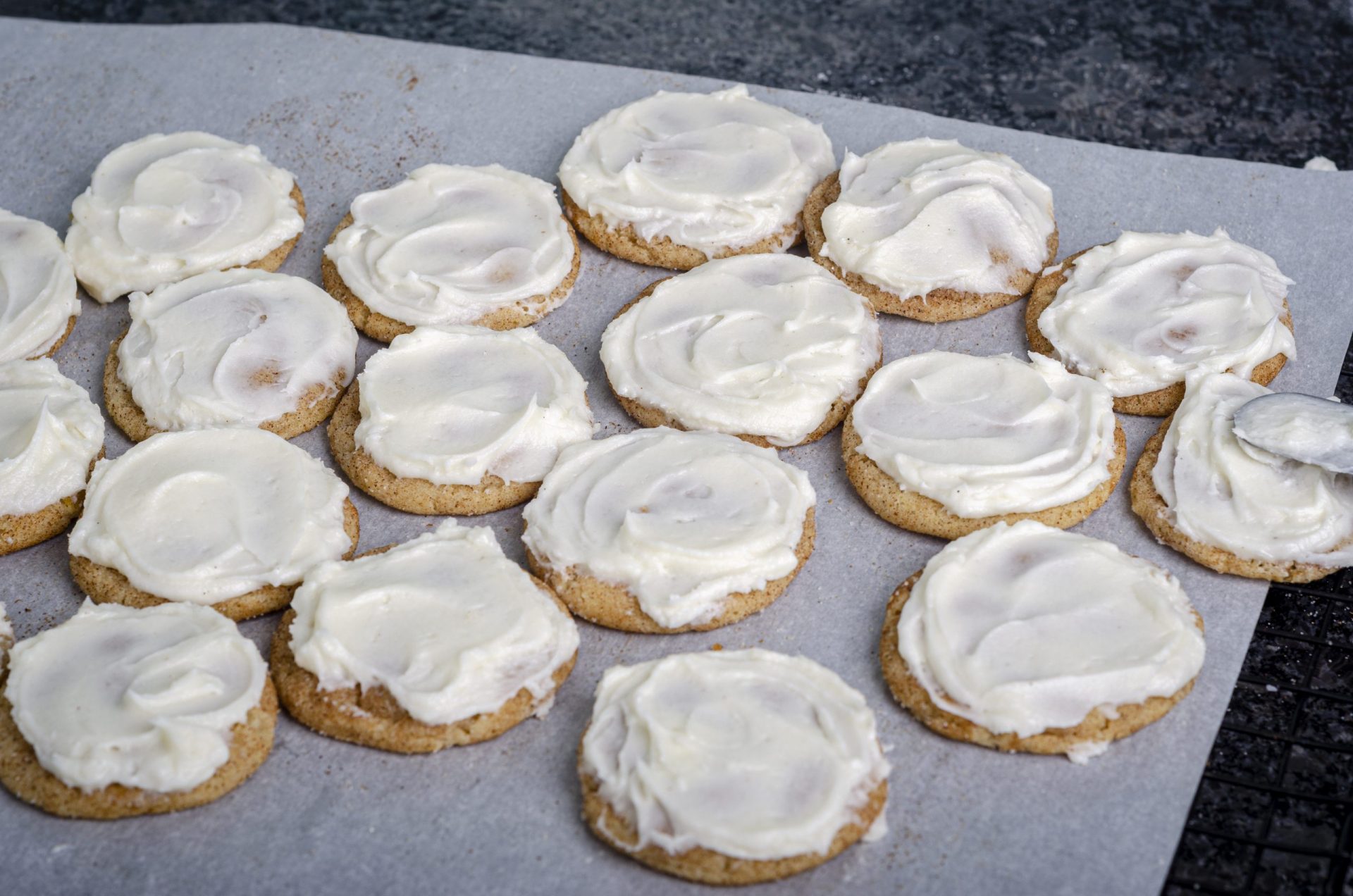 frosted cookies on parchment paper