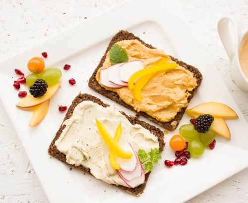 whole wheat bread with nut spread and fruit on the side