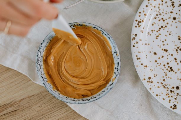 Bowl of PB with plastic knife in it