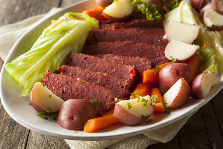 corned beef on a platter with potatoes, carrots, cabbage