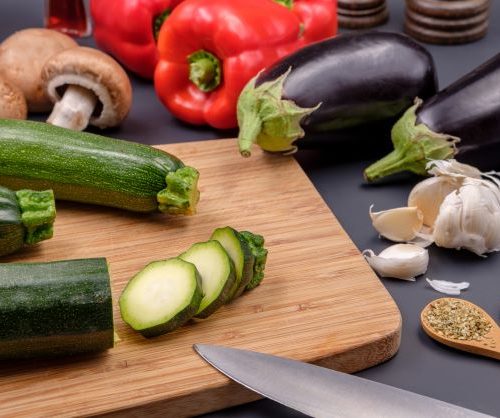 veggies on and surrounding cutting board