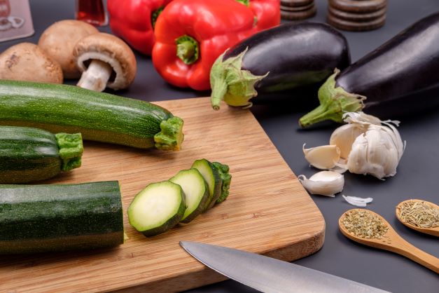 veggies on and surrounding cutting board