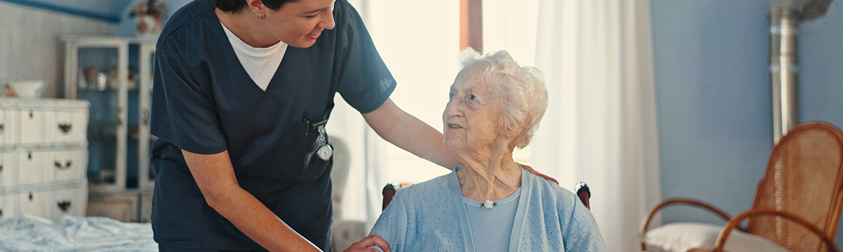 Photograph of an older adult using a walker to move through a well-lit home hallway with supportive handrails and wide doorways. This image supports the UW Extension A.G.E. blog article titled 'Home Modifications Can Promote Aging in Place.