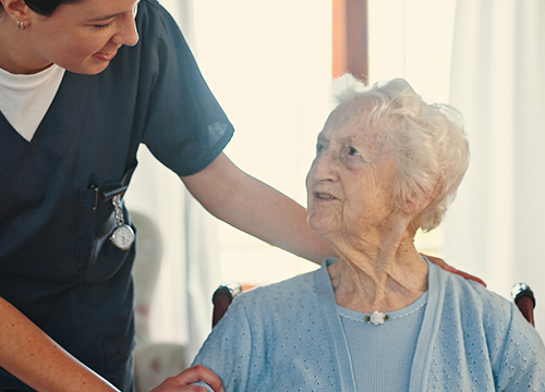 Photograph of an older adult using a walker to move through a well-lit home hallway with supportive handrails and wide doorways. This image supports the UW Extension A.G.E. blog article titled 'Home Modifications Can Promote Aging in Place.
